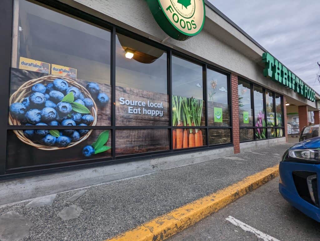 Custom grocery store sign with fresh fruits and vegetables display.