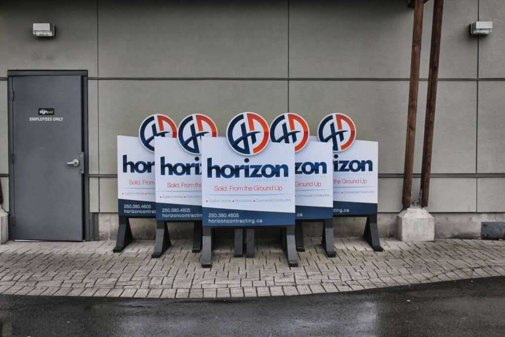 Five Horizon Sound signs displayed outside a building on sidewalk.