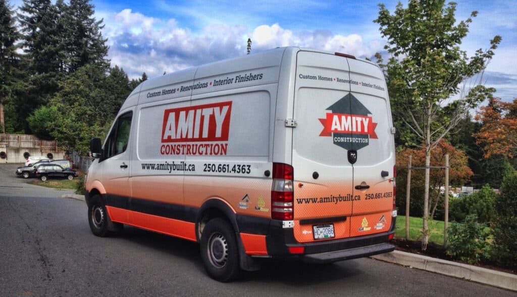 Amity Construction branded work van with custom signage for construction services.