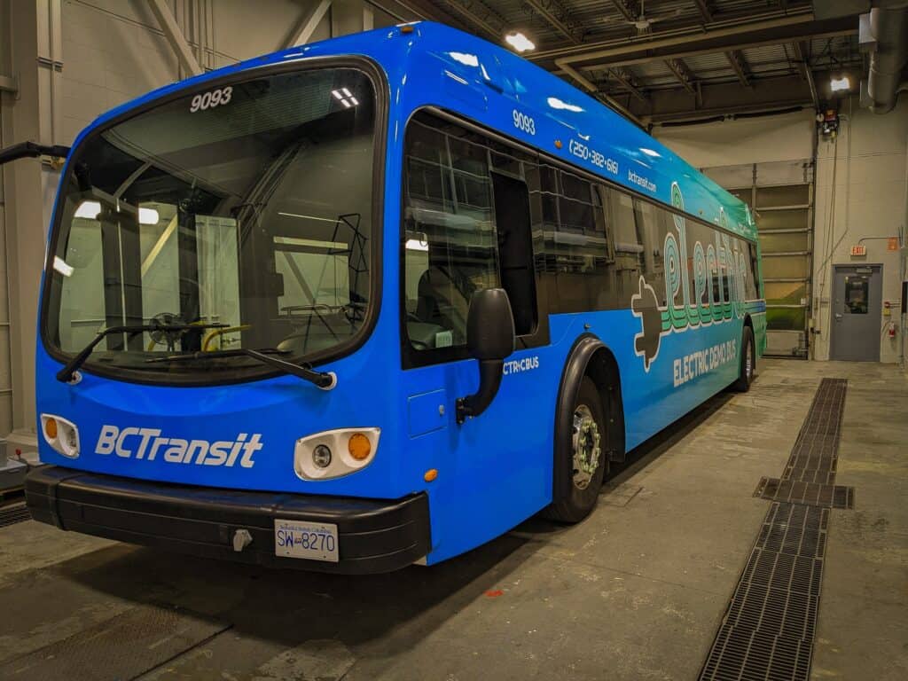 Electric shuttle bus with medical and healthcare signage.