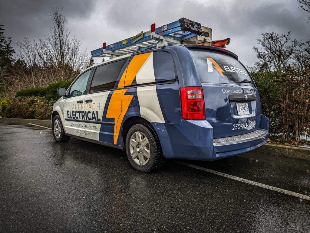 Electrical service vehicle with custom signage and branding.