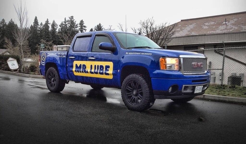 Blue Mr. Lube service truck parked on the street.