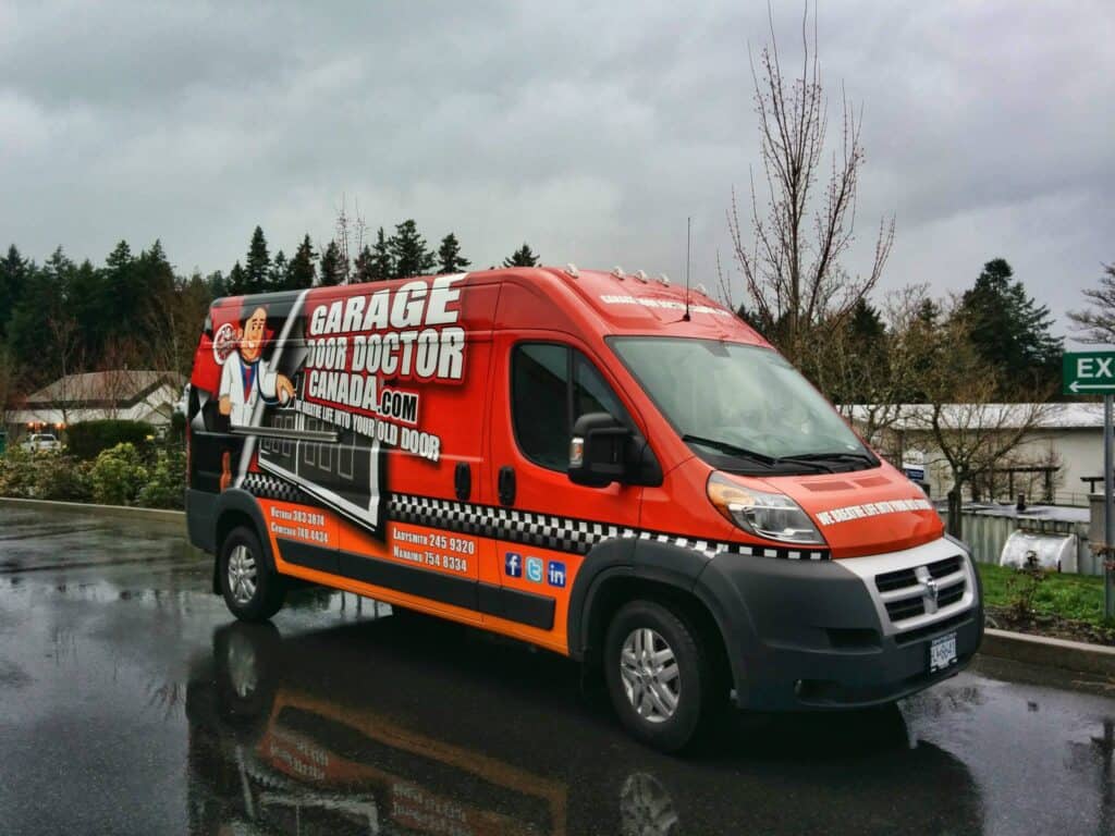 Custom vehicle wrap for Garage Door Doctor on a red van in Victoria.