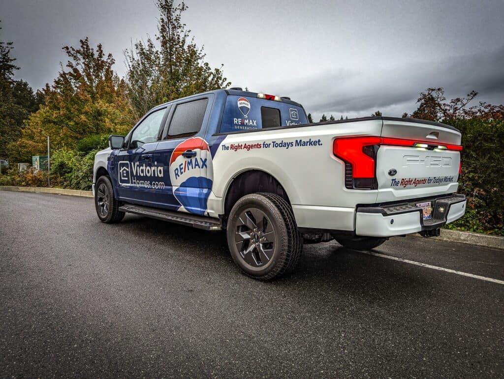 RE/MAX branded vehicle with custom signage and graphics.
