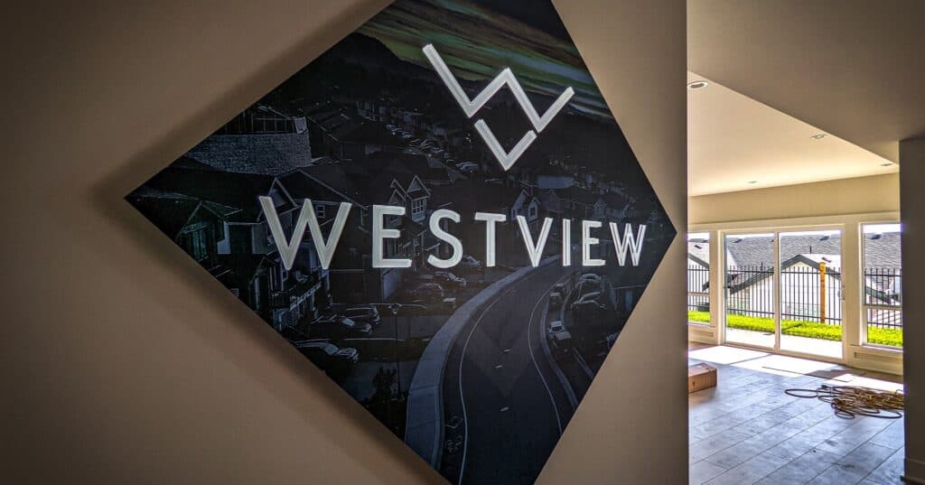 Modern Westview sign with logo and street view background, indoor display.