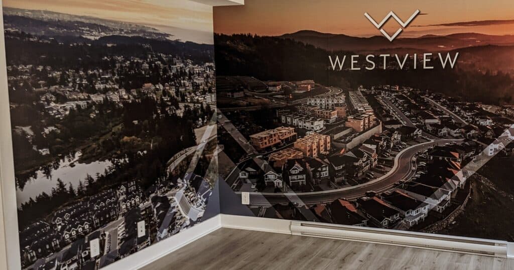 Custom Westview sign on interior wall with cityscape mural.