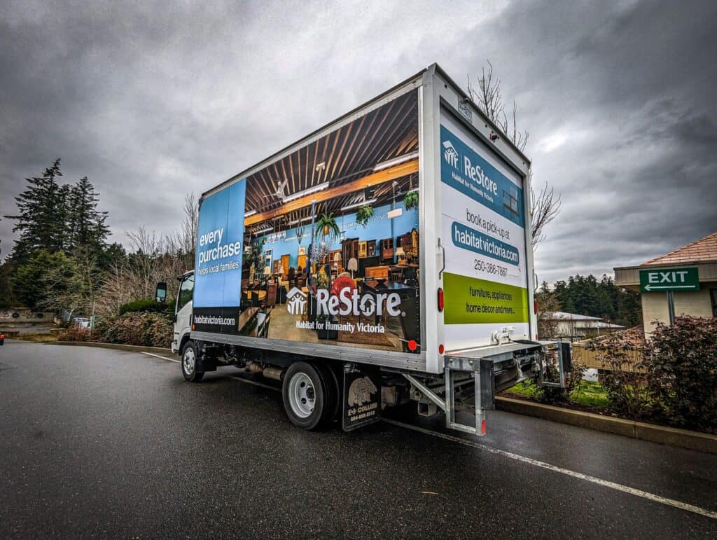 Rescue shelter vehicle wrap promoting community support.