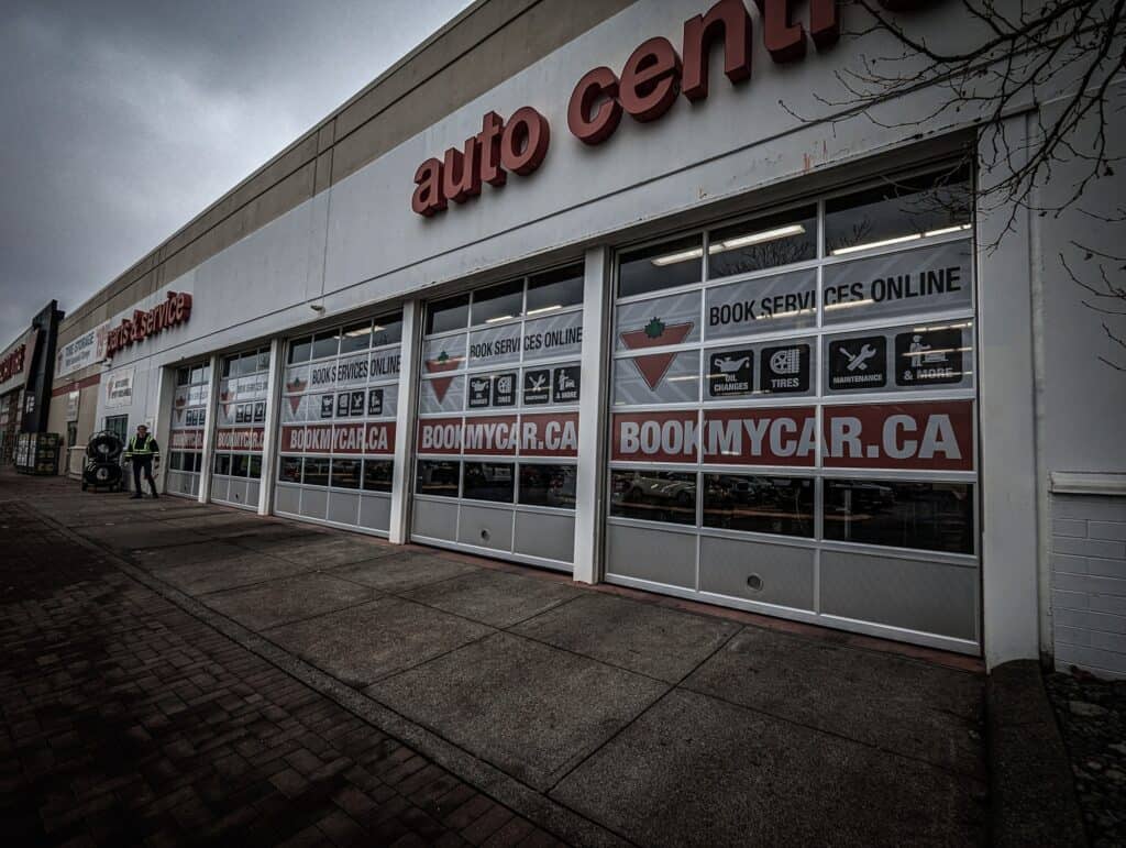 Auto center storefront with custom signs and vehicle wraps in Victoria, showcasing branding and adve.