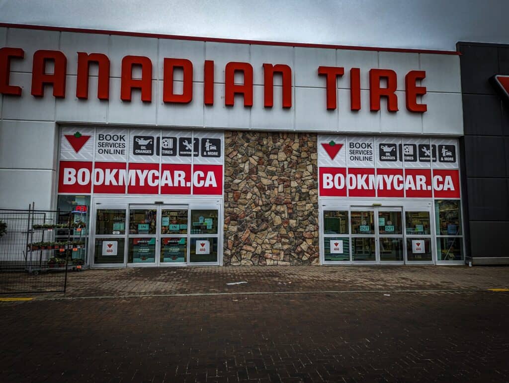 Canadian Tire Storefront with vehicle wrap advertising and booking service signs.