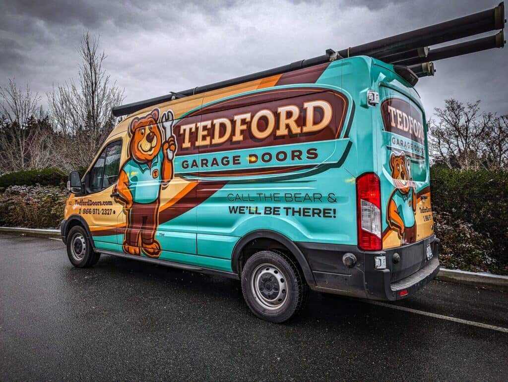 Custom vehicle wrap for Tedford Garage Doors featuring a bear mascot and vibrant branding.