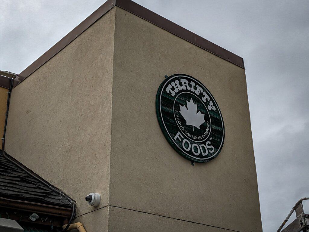 Tharles Foods logo sign on the exterior wall of a building in Victoria.