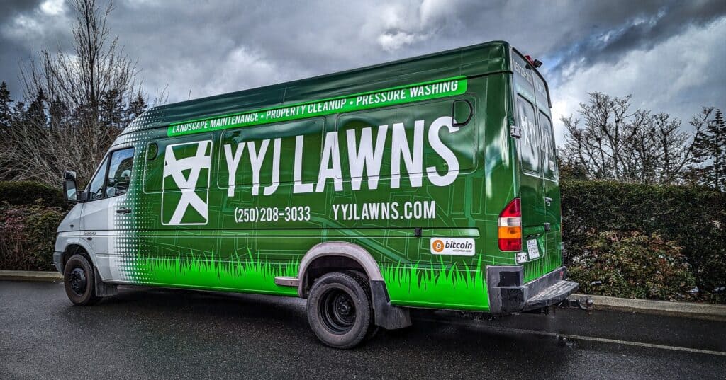 Yylawn landscaping van with custom signage in Victoria, offering lawn maintenance and pressure washi.