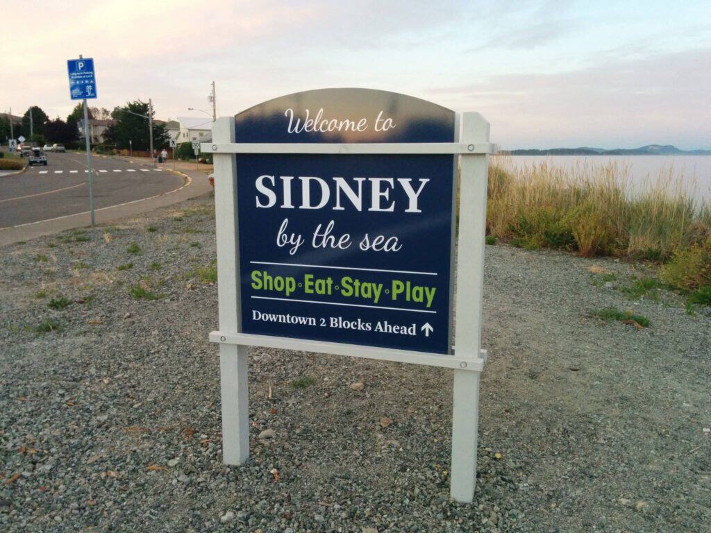 Welcome to Sidney by the sea sign with vibrant colors and clear messaging.