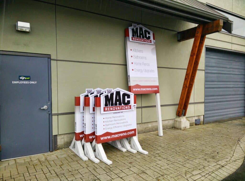 Outdoor sign display for MAC Renovations with multiple signs and a sign pad.