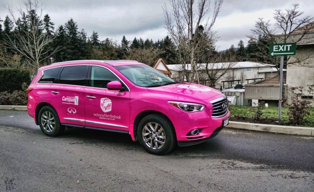 Pink vehicle wrap with business branding on SUV in Victoria.