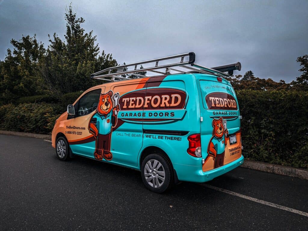 Custom vehicle wrap for Tedford Garage Doors featuring a bear mascot.