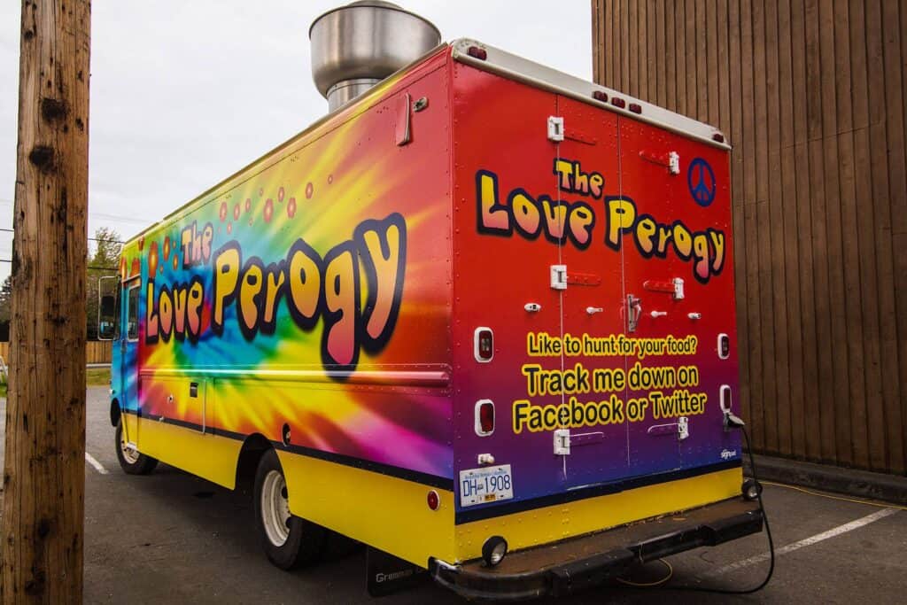Bright colorful sign for The Love Percy vehicle wrap.