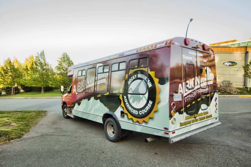 Custom wrapped bus promoting Rocky Mountain Adventure Tours in Victoria.