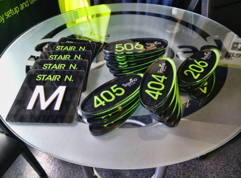 Custom green and black stair signage with "STAIR N." and golf ball markers with numbers 405, 404, 50.