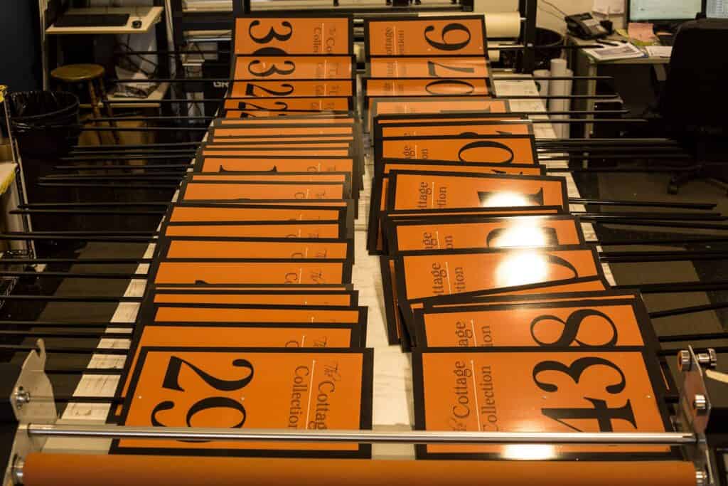 Custom signs and vehicle wraps displayed on a foosball table in Victoria.