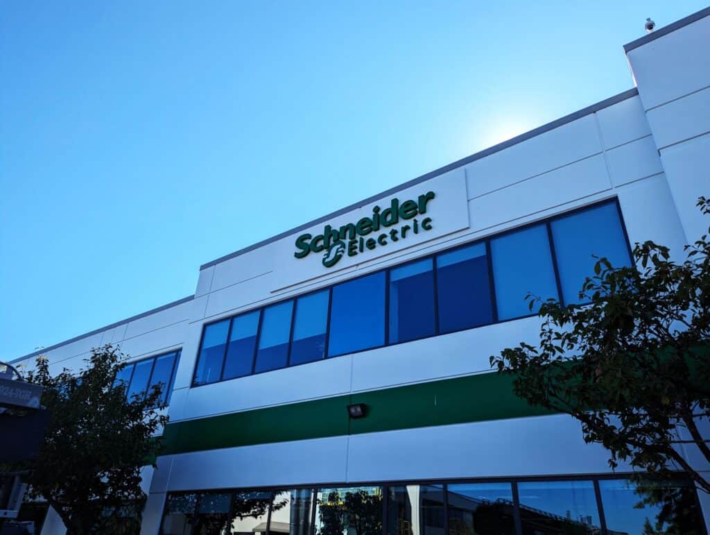 Exterior view of Schneider Electric office with company sign on modern building.