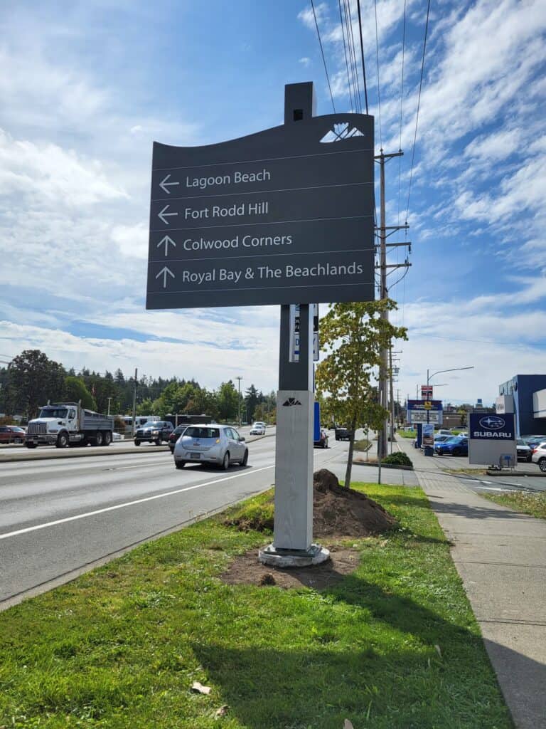 Directional sign with multiple arrows pointing to Lagoon Beach, Fort Rodd Hill, Colwood Corners, and.