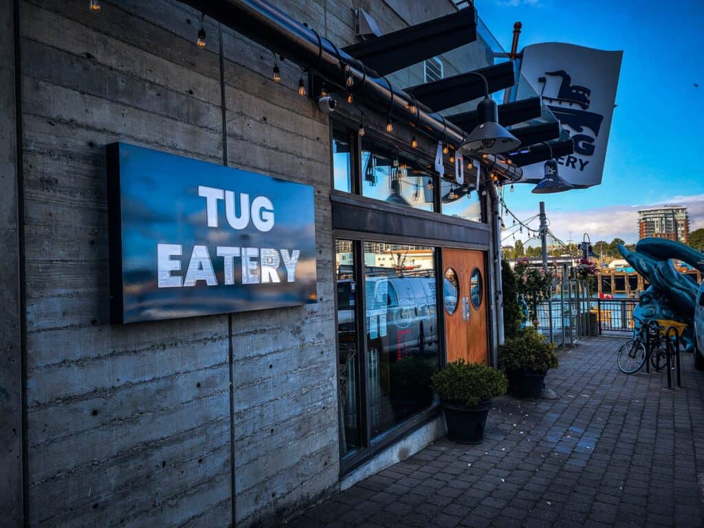Tug Eatery business sign on the restaurant's exterior wall.