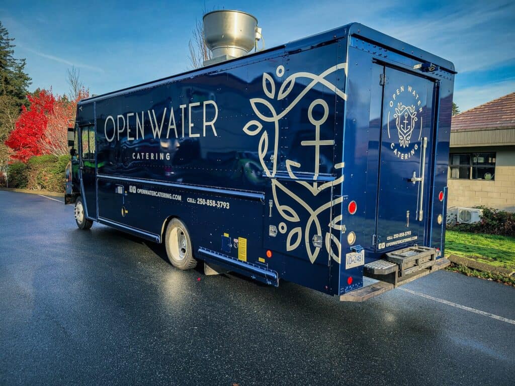 Custom catering truck with Open Water branding and nautical design.