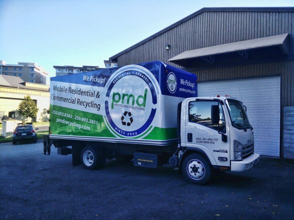 Vehicle wrap promoting recycling services in Victoria, featuring the company logo and contact inform.