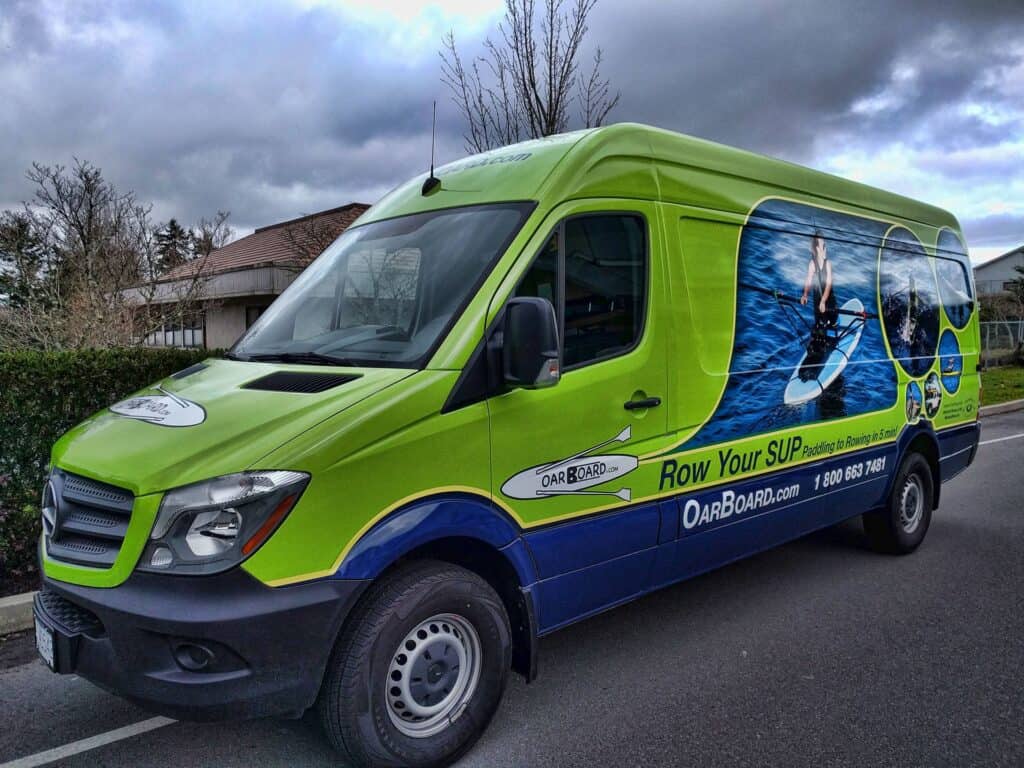 Bright green and blue water sports vehicle wrap promoting OAR Board.