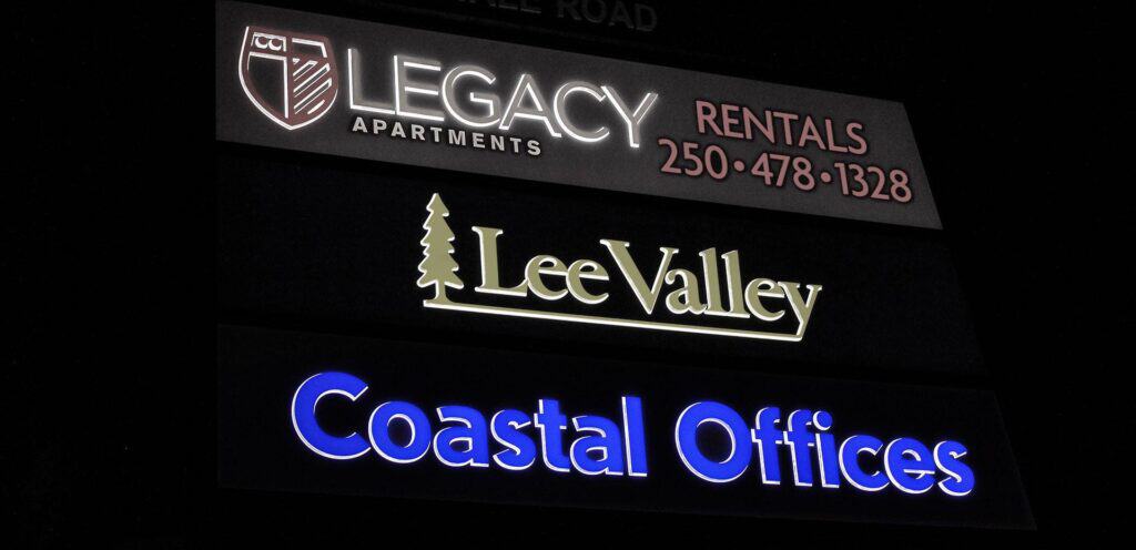 Signboard displaying Legacy Apartments, Lee Valley, and Coastal Offices in Victoria.