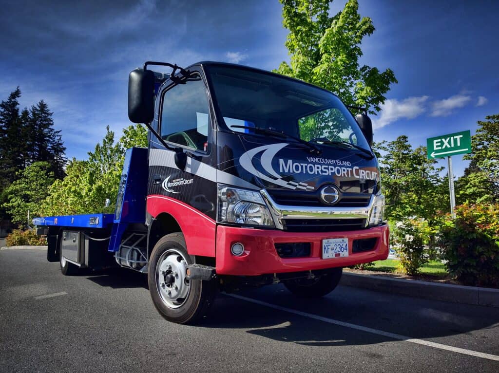 Vehicle wrap for motorsport circuit branding.