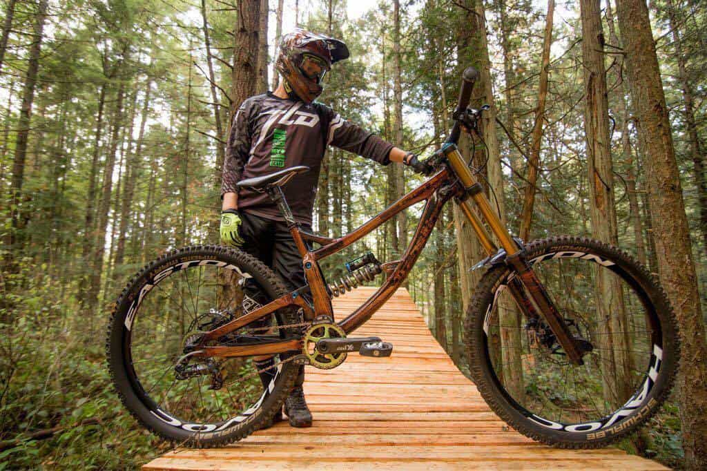 Mountain biker with full gear on a forest trail.