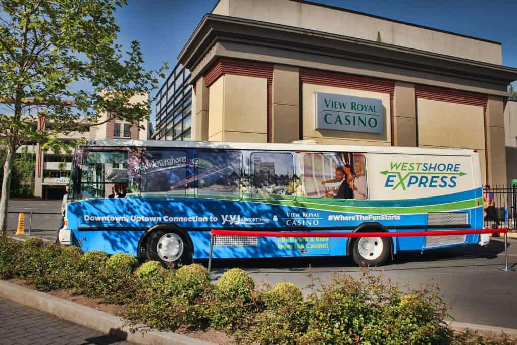 Bus with custom casino and transit advertising wrap in Victoria.