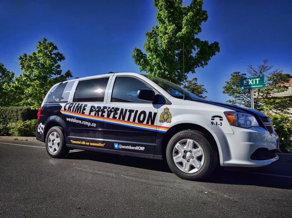 Emergency vehicle with crime prevention signage in Victoria.