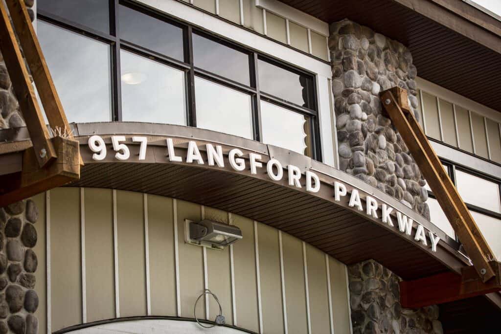 Custom sign reading "957 Langford Parkway" on building exterior.