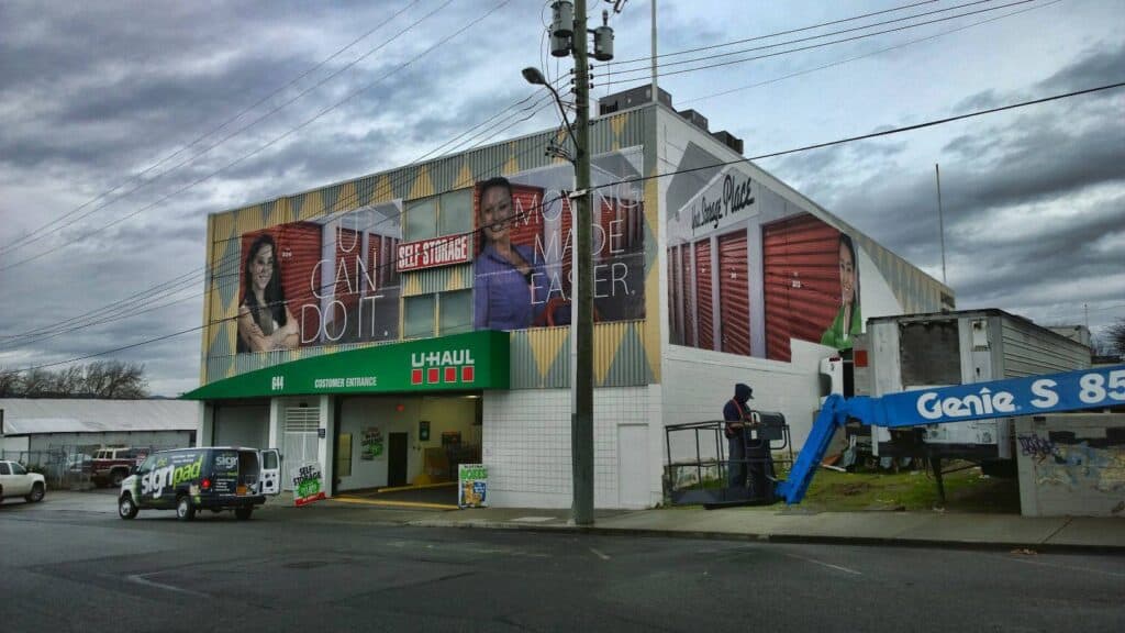 Large building with vibrant custom signs and vehicle wraps in Victoria.