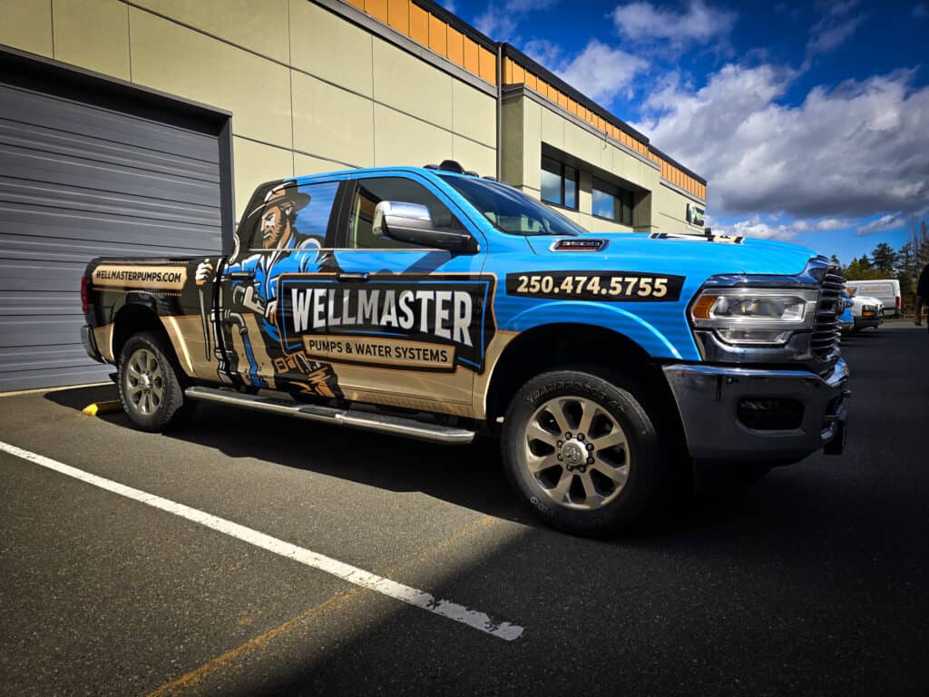 Custom vehicle wrap for Wellmaster plumbing and water systems on a blue truck.