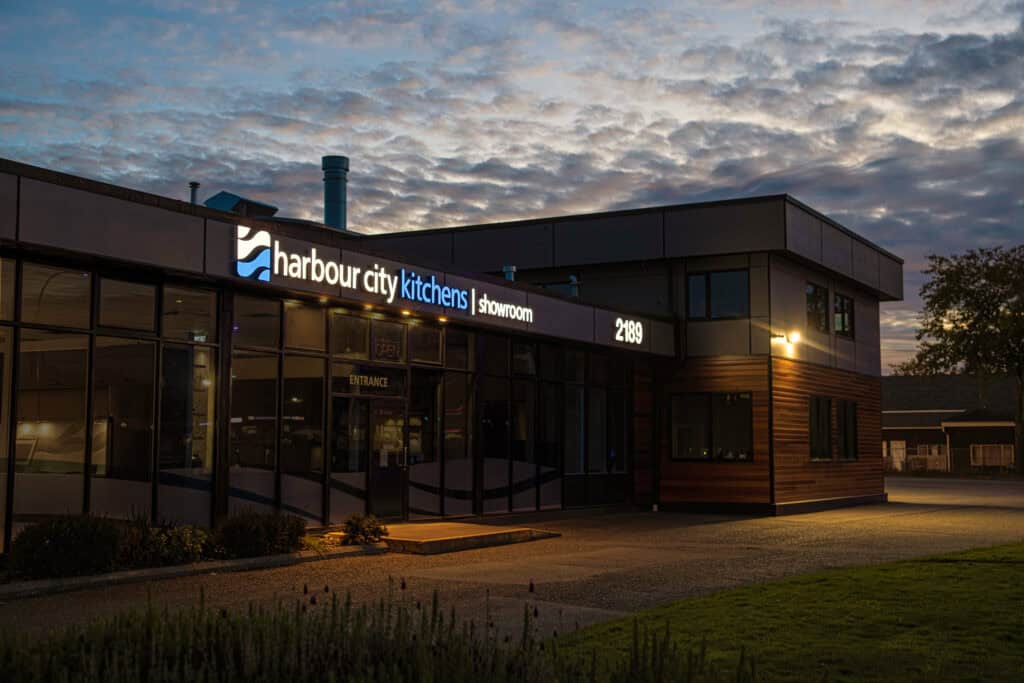 Harbour City Kitchens storefront sign at dusk in Victoria.