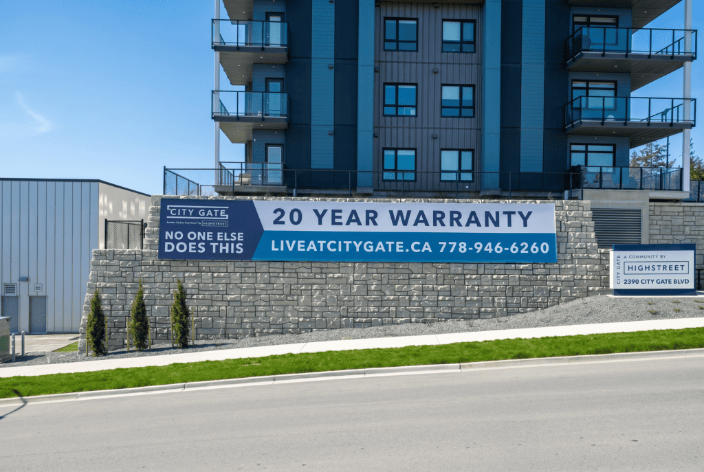 Sign promoting 20-year warranty at City Gate with contact info.