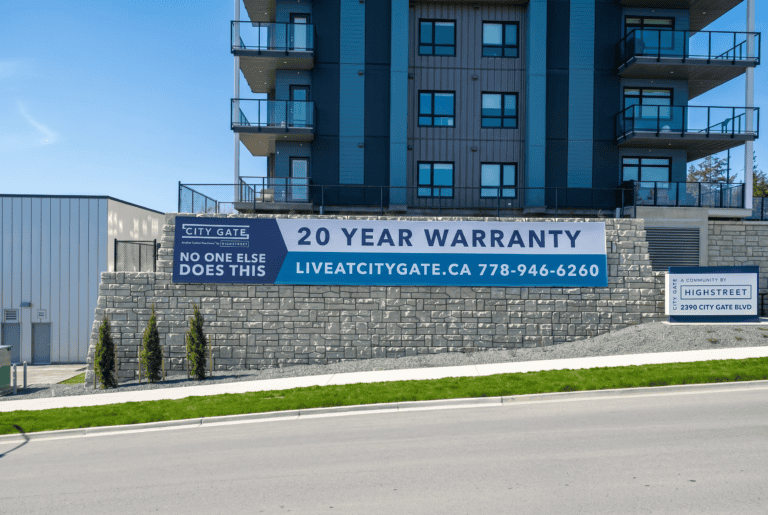 Sign promoting 20-year warranty at City Gate with contact info.