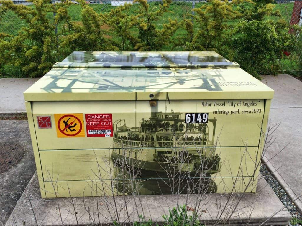 Sign box with vintage boat graphic and safety warning.