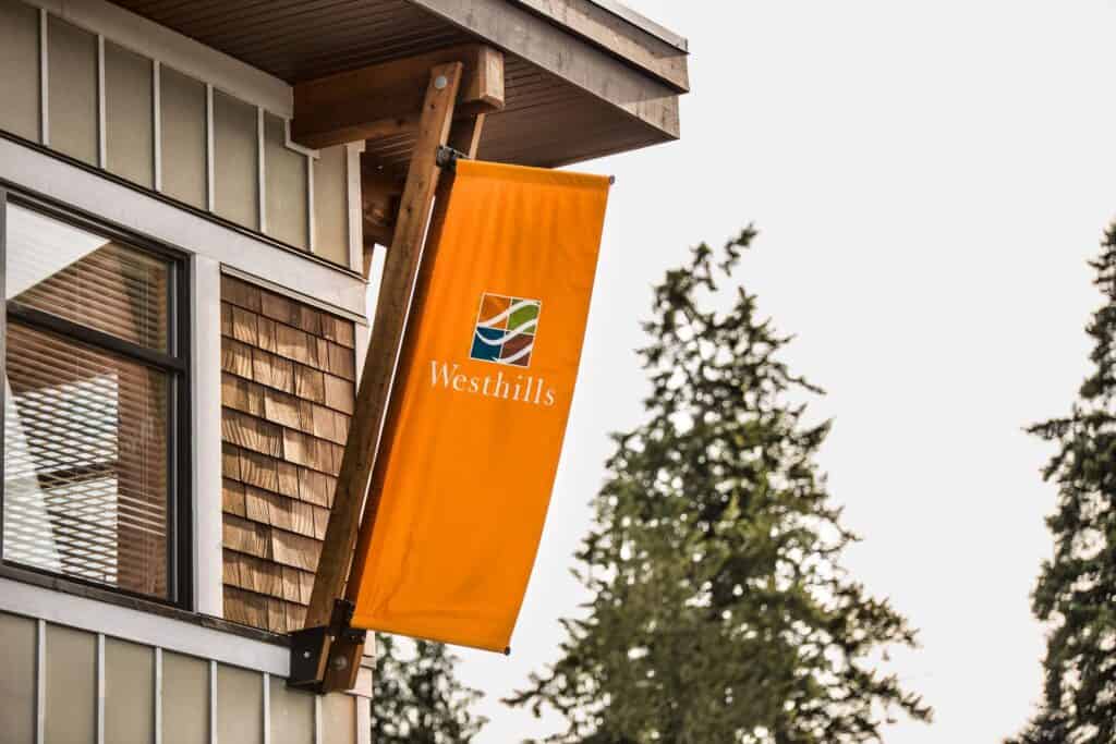 Orange Westhills banner mounted on building exterior.