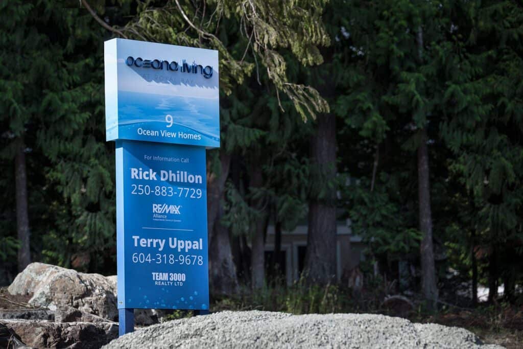 Ocean View Homes sign with contact info in Victoria.