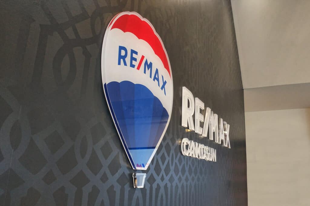 RE/MAX hot air balloon logo with company name on wall.