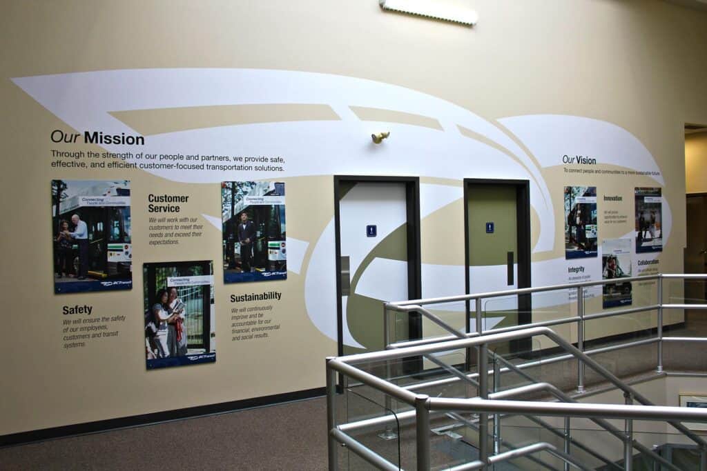 Indoor wall with custom signs and mission statements in a corporate setting.