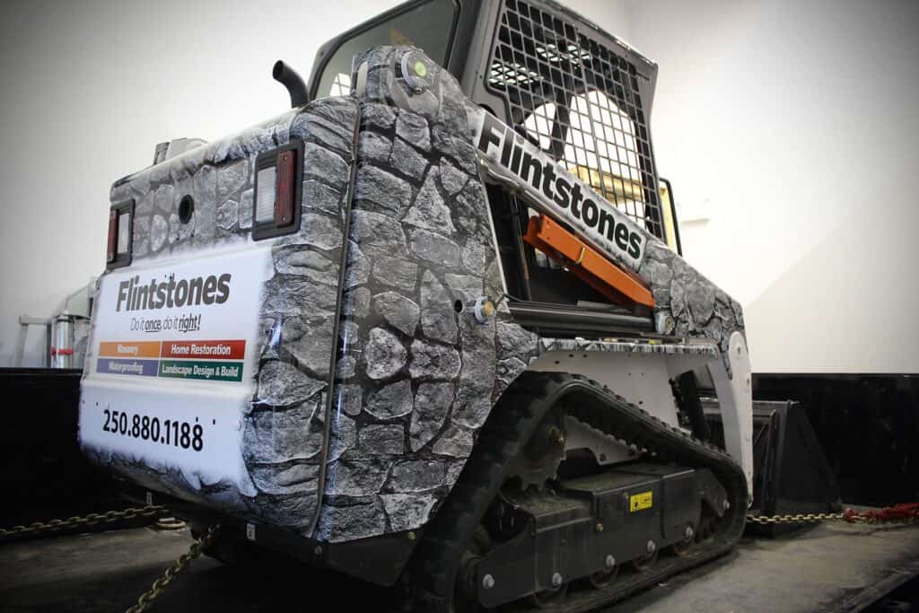 Stone-textured vehicle wrap for Flintstones signage and branding.