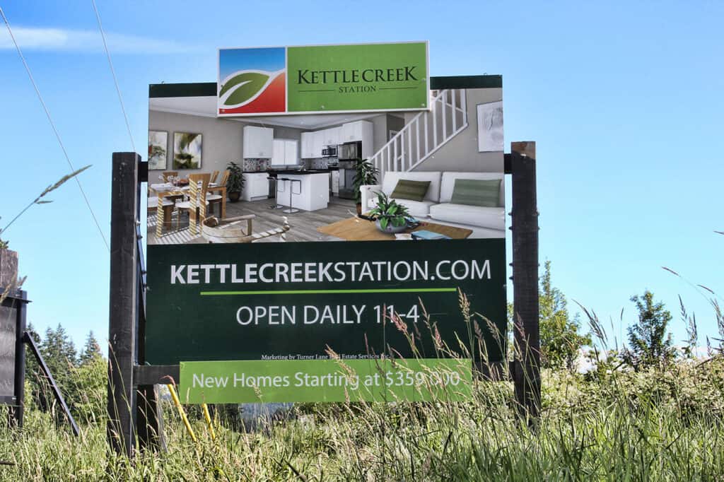 Kettle Creek Station outdoor sign with business info and opening hours.