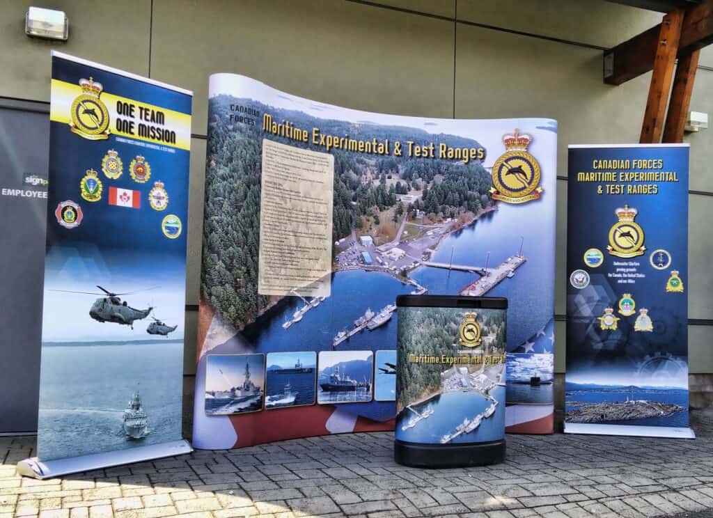 Maritime experimental and test range display with military logos and ships.