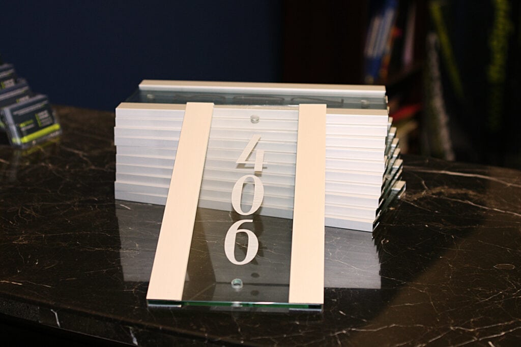 Custom acrylic sign with the number 406 for business branding.